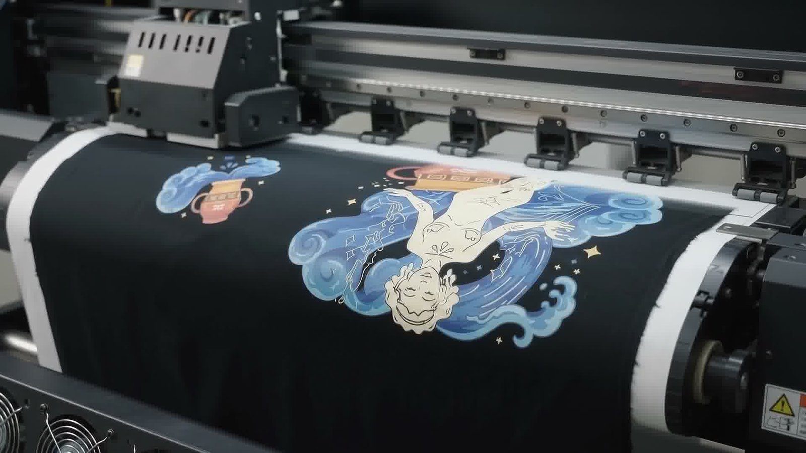 The Aquarius artwork being printed across black fabric